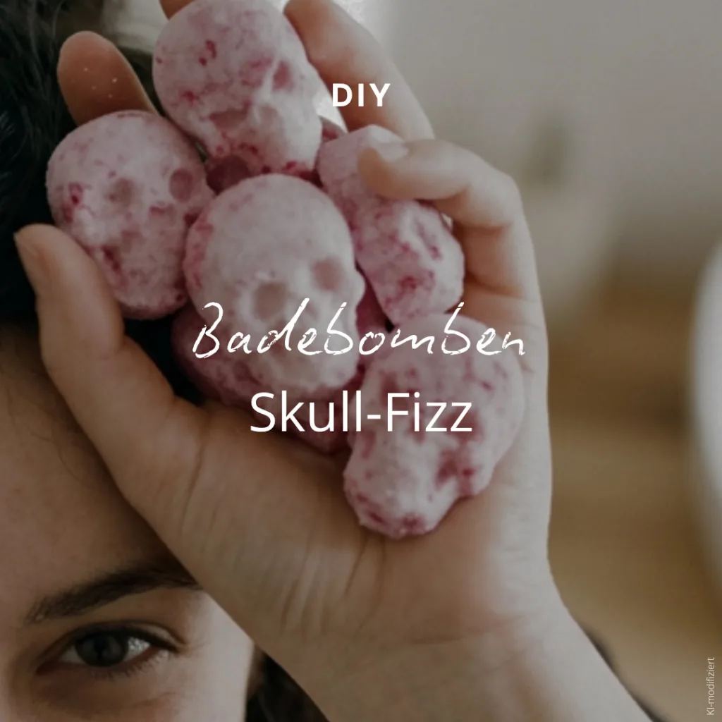 Eine Hand, die mehrere rosa, totenschädelförmige Badebomben hält, darüber der Schriftzug DIY Badebomben Skull-Fizz.
